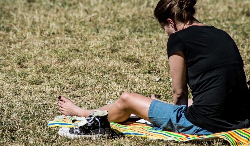 What’s a Skin Cancer Action Week? By Your Health Hub woman sitting in the sun